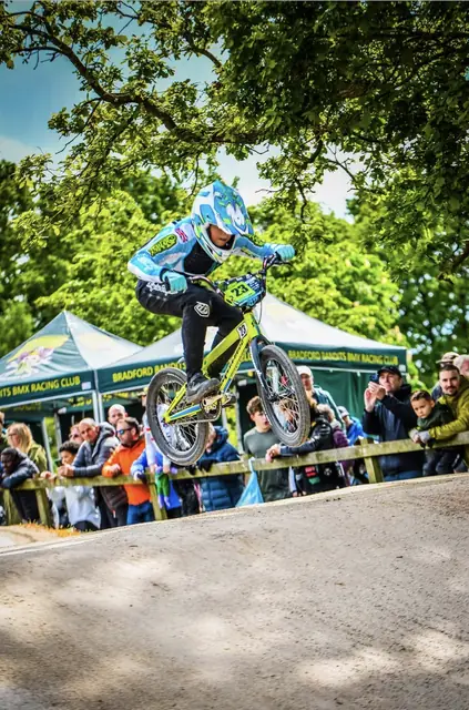 Jumping past the team tents