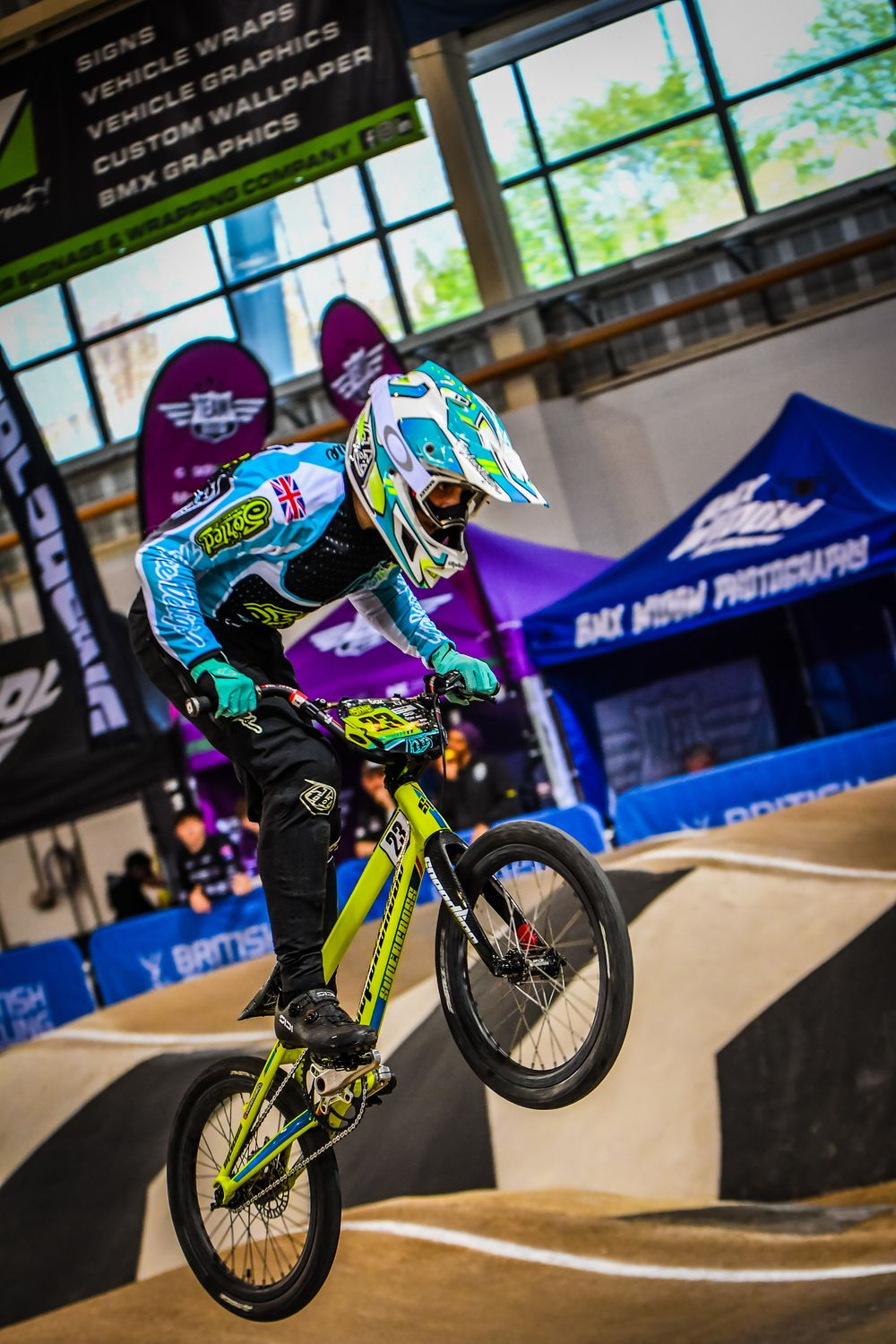 Charlie in the air over an indoor BMX jump