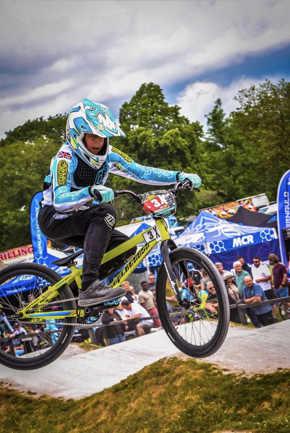Charlie airborne past the crowd at an outdoor race